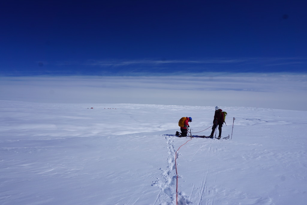 Setting an anchor to scout out a potential moulin instrumentation site.